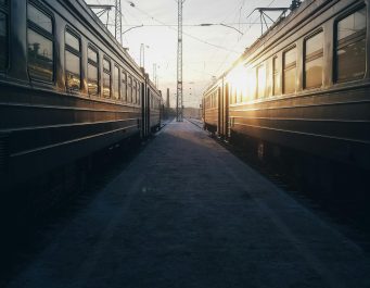 A couple of train cars are parked next to each other